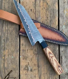Close-up of copper Damascus steel blade pattern 8 inch chef knife.