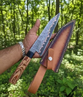 Full tang Damascus chefs knife with buffalo horn bolster.